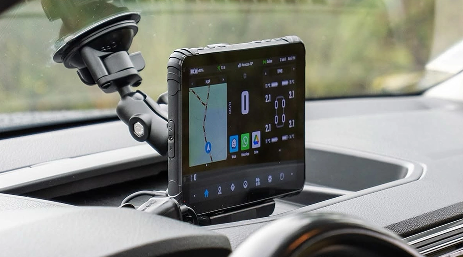 Fleet manager monitoring multiple vehicles on tablet dashboard